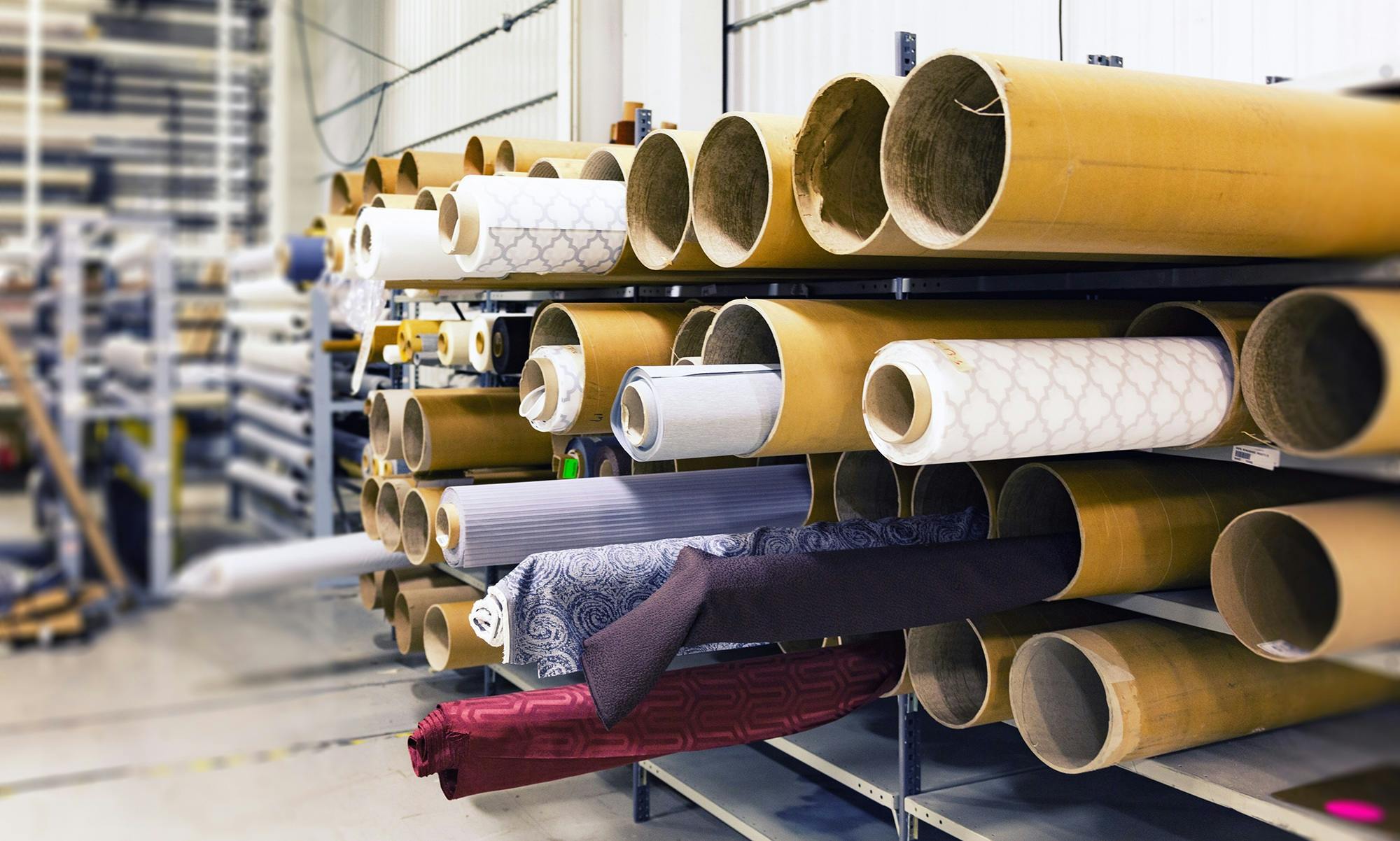 Professional tailor measuring and marking fabric for alterations